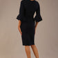 brunette model is wearing a diva catwalk Hobson ruffled sleeves Pencil Dress with tie waistband knee length in Dark Navy colour back