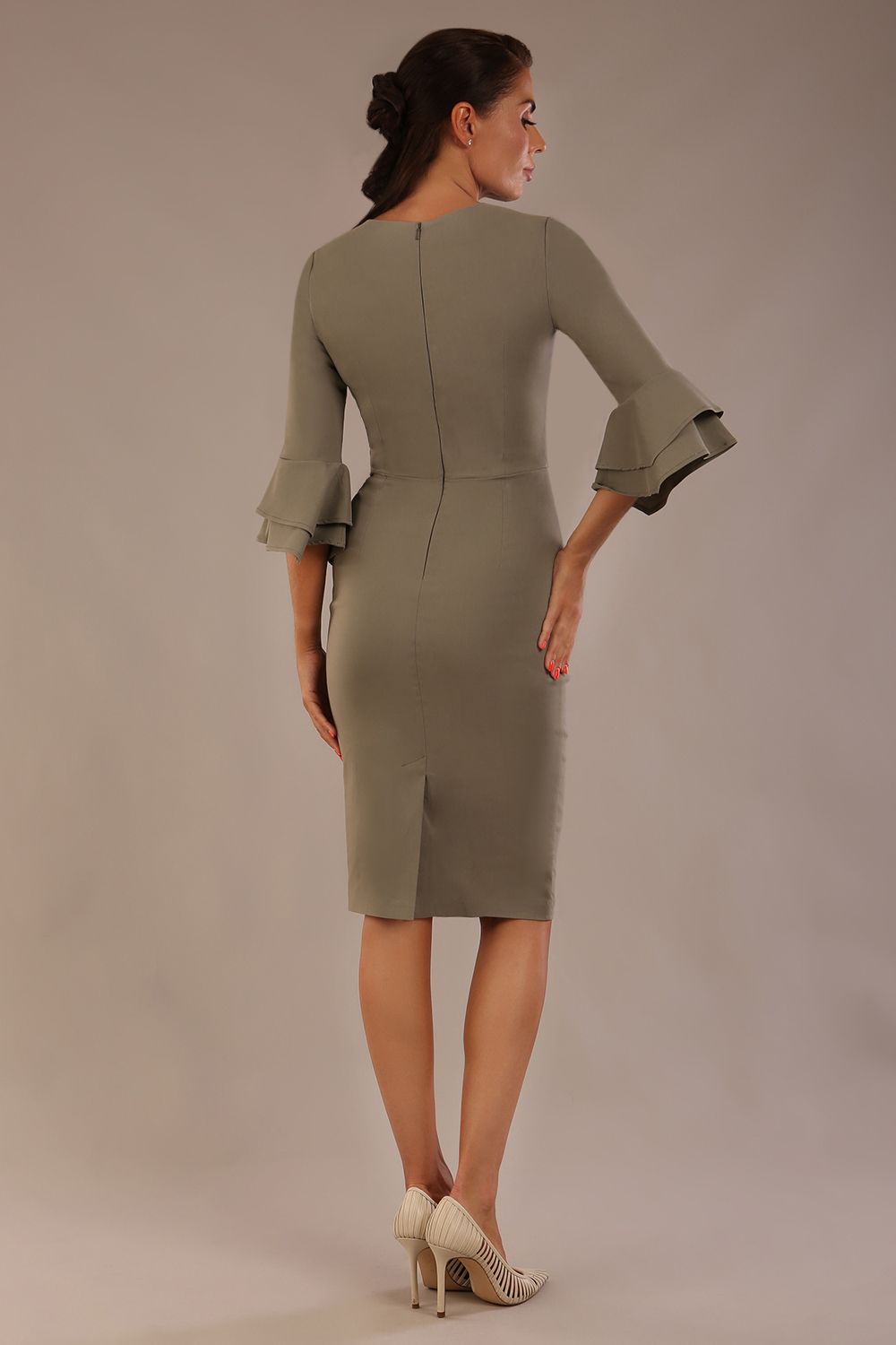 brunette model is wearing a diva catwalk Hobson ruffled sleeves Pencil Dress with tie waistband knee length in Castlerock Grey colour back