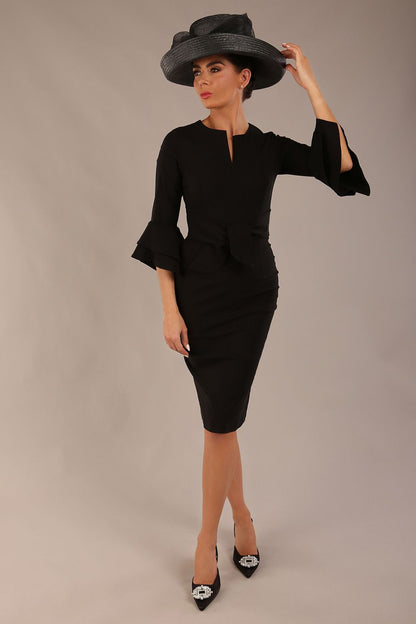 brunette model is wearing a diva catwalk Hobson ruffled sleeves Pencil Dress with tie waistband knee length in Black colour front with a hat