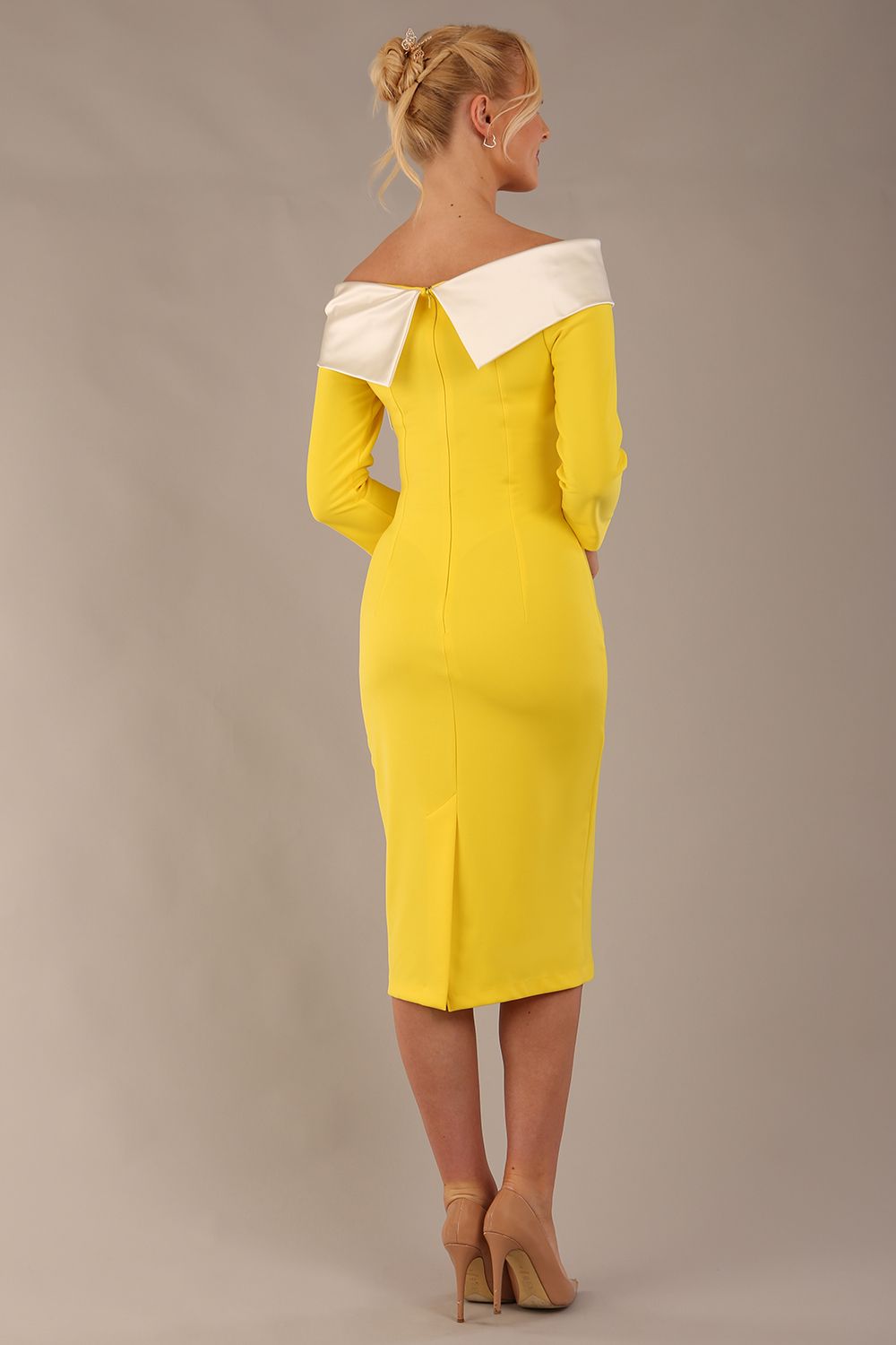 brunette Model is wearing a Rosalind Off Shoulder Bow Detail Pencil Dress 3/4 sleeve in Blazing Yellow / Ivory cream contrast back image (Blazing Yellow / Ivory)