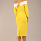 brunette Model is wearing a Rosalind Off Shoulder Bow Detail Pencil Dress 3/4 sleeve in Blazing Yellow / Ivory cream contrast back image