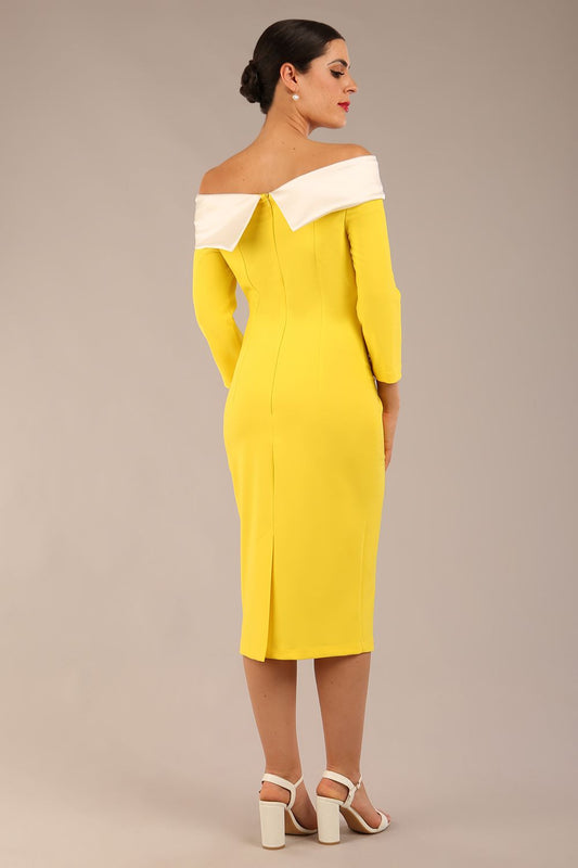 brunette Model is wearing a Rosalind Off Shoulder Bow Detail Pencil Dress 3/4 sleeve in Blazing Yellow / Ivory cream contrast back image