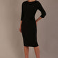 Woman wearing a Heathcote Floral Detail Pencil Dress with a plain background in black front view