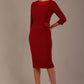 Woman wearing a Heathcote Floral Detail Pencil Dress with a plain background in rosewood red front view