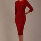 Woman wearing a Heathcote Floral Detail Pencil Dress with a plain background in rosewood red colour