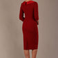 Woman wearing a Heathcote Floral Detail Pencil Dress with a plain background in rosewood red back view