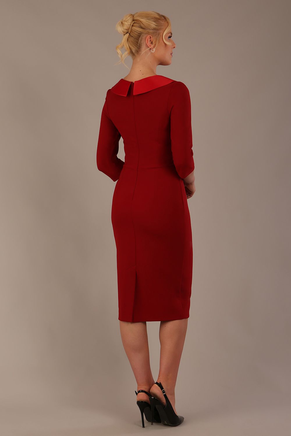 Woman wearing a Heathcote Floral Detail Pencil Dress with a plain background in rosewood red back view