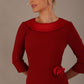 Woman wearing a Heathcote Floral Detail Pencil Dress with a plain background in rosewood red close up view