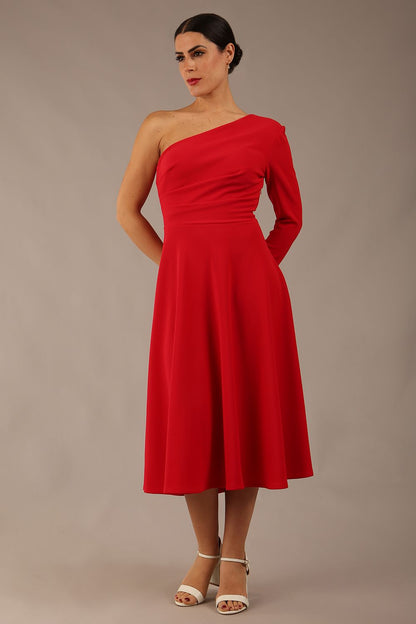 brunette model wearing a diva catwalk Beverley One Shoulder A-line Dress in ribbed super stretch fabric and one long sleeve a-line skirt midi length in true red colour front