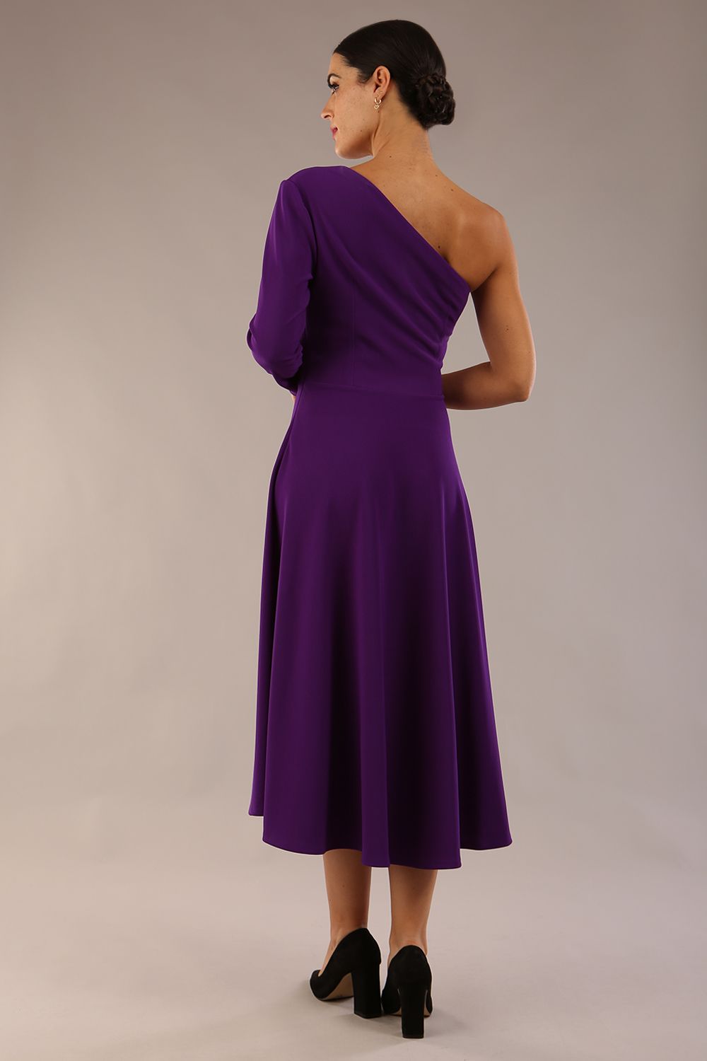 model wearing a diva catwalk Beverley One Shoulder A-line Dress in ribbed super stretch fabric and one long sleeve a-line skirt midi length in passion purple colour back