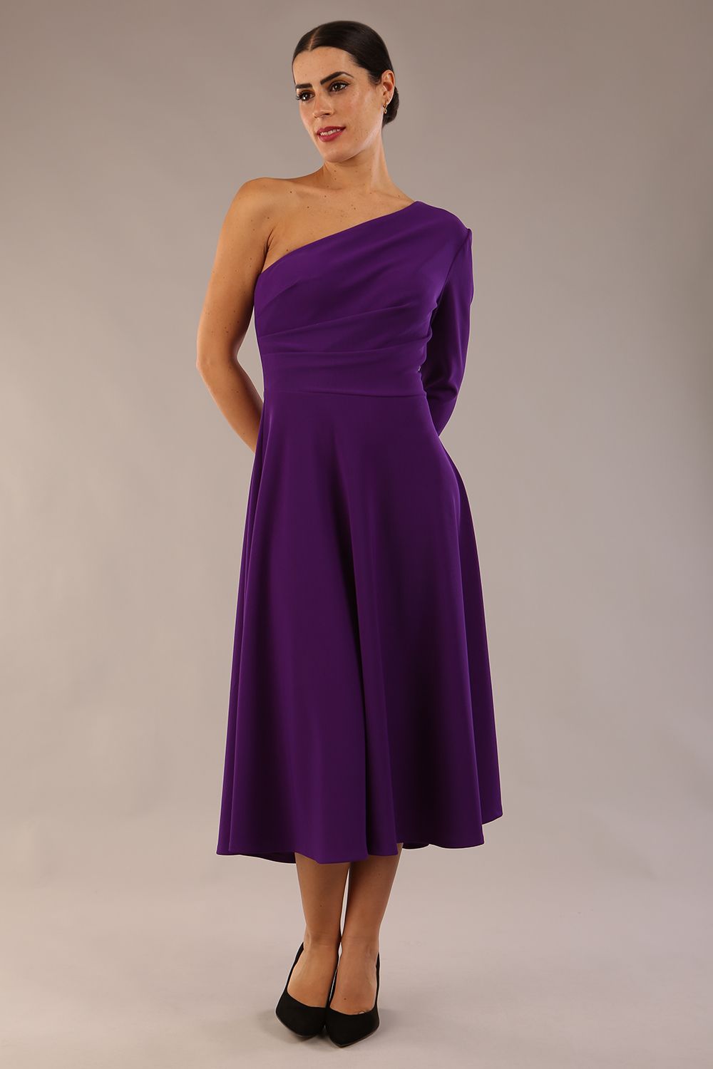 model wearing a diva catwalk Beverley One Shoulder A-line Dress in ribbed super stretch fabric and one long sleeve a-line skirt midi length in passion purple colour front