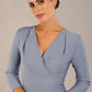 model wearing a diva catwalk pleated shoulder detail of the SEED Addison pencil dress (Steel Blue)