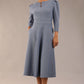 A model wearing a red, 3/4 sleeve A-line dress with pockets, featuring a boat neckline and vent at the centre back (Steel Blue)