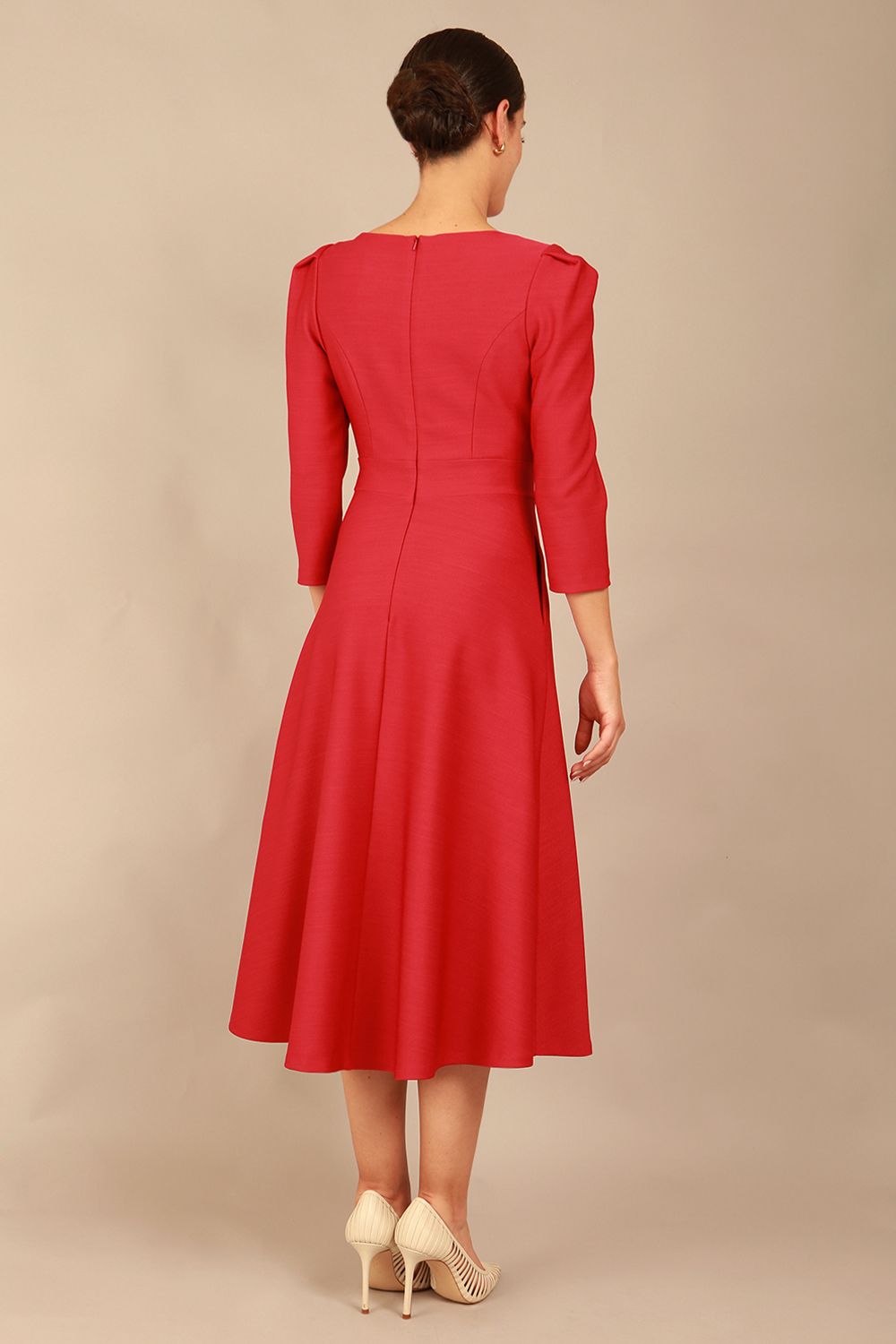 A model wearing a red, 3/4 sleeve A-line dress with pockets, featuring a boat neckline and vent at the centre back (Crimson Pink)