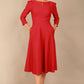 A model wearing a red, 3/4 sleeve A-line dress with pockets, featuring a boat neckline and vent at the centre back (Crimson Pink)