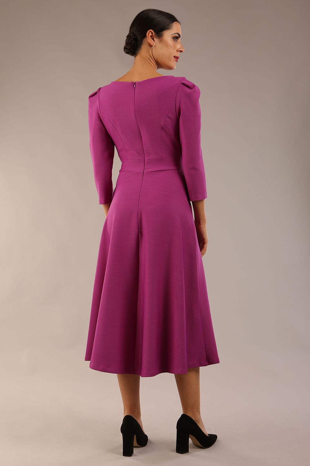 A model wearing a red, 3/4 sleeve A-line dress with pockets, featuring a boat neckline and vent at the centre back (Dawn Purple)