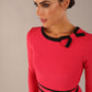 Model wearing a diva catwalk SEED Bethany dress in opera pink, showing the black contrast trim and bow detail (Opera Pink / Black)