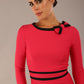 Model wearing a diva catwalk SEED Bethany dress in opera pink, showing the black contrast trim and bow detail (Opera Pink / Black)