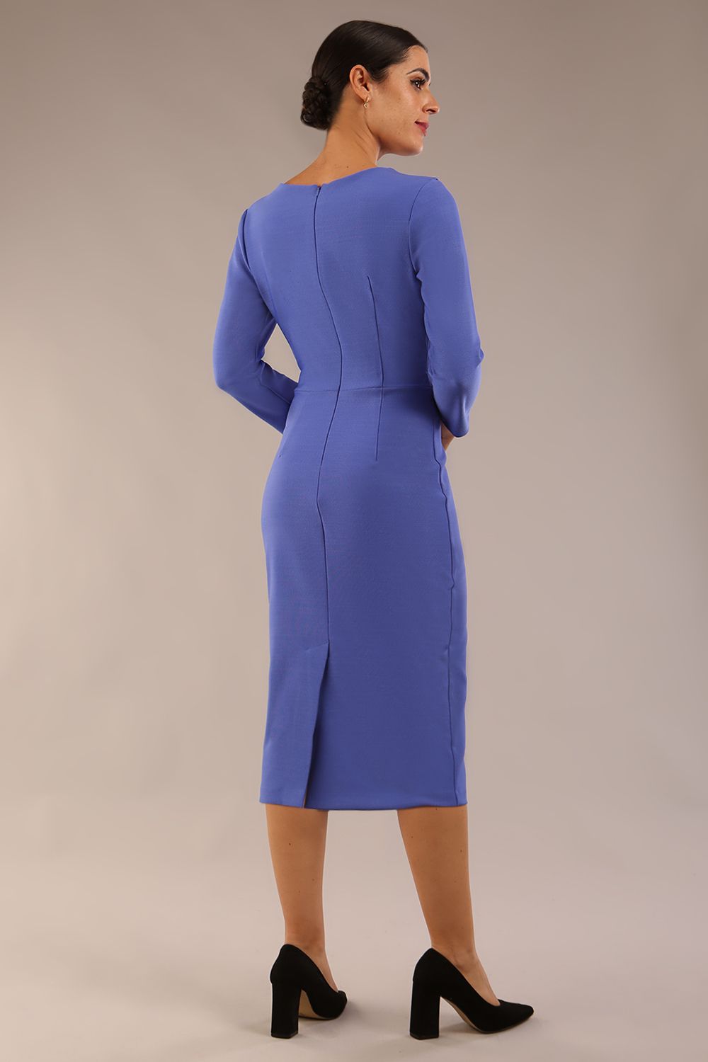 A woman modeling the diva catwalk  SEED Dolores cascade ruffle pencil dress in thistle blue with a v-neckline and concealed zip at the back (Thistle blue)