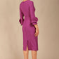 Model wearing the diva catwalk SEED Cicely rosette cuff pencil dress highlighting the asymmetric pleated waist and sculpted fit (Amethyst Purple)