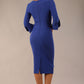 Model wearing the diva catwalk SEED Cicely rosette cuff pencil dress highlighting the asymmetric pleated waist and sculpted fit (Monaco Blue)