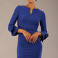Model wearing the diva catwalk SEED Cicely rosette cuff pencil dress highlighting the asymmetric pleated waist and sculpted fit (Monaco Blue)