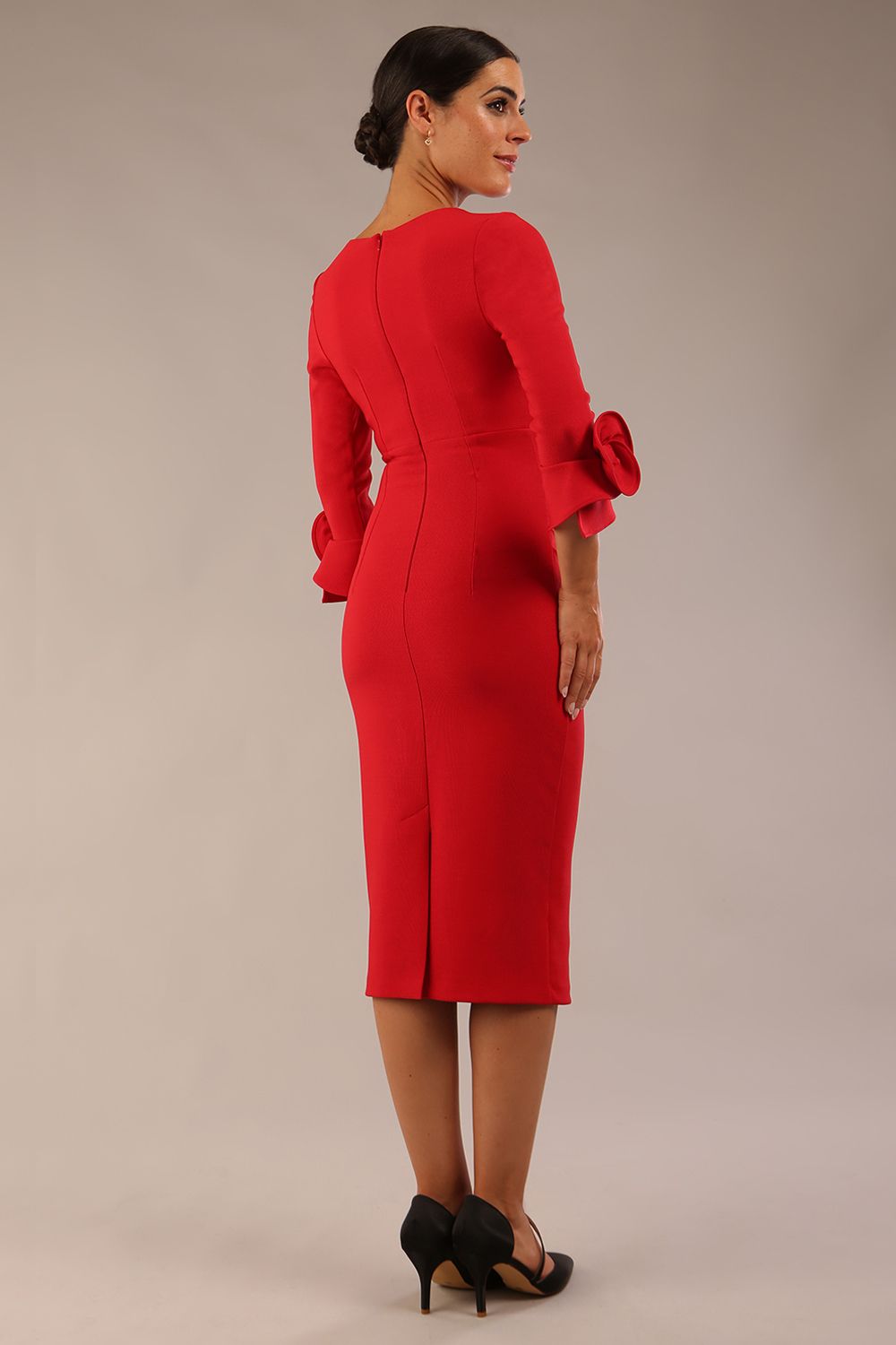 Model wearing the diva catwalk SEED Cicely rosette cuff pencil dress highlighting the asymmetric pleated waist and sculpted fit (Salsa Red)