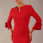 Model wearing the diva catwalk SEED Cicely rosette cuff pencil dress highlighting the asymmetric pleated waist and sculpted fit (Salsa Red)