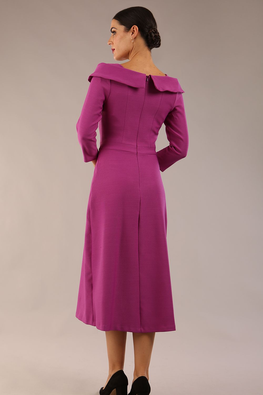A model wearing a diva catwalk SEED Chrysanta sculptural collar dress 3/4 sleeve A-line dress with a round neckline and concealed zip at the back (Dawn Purple)