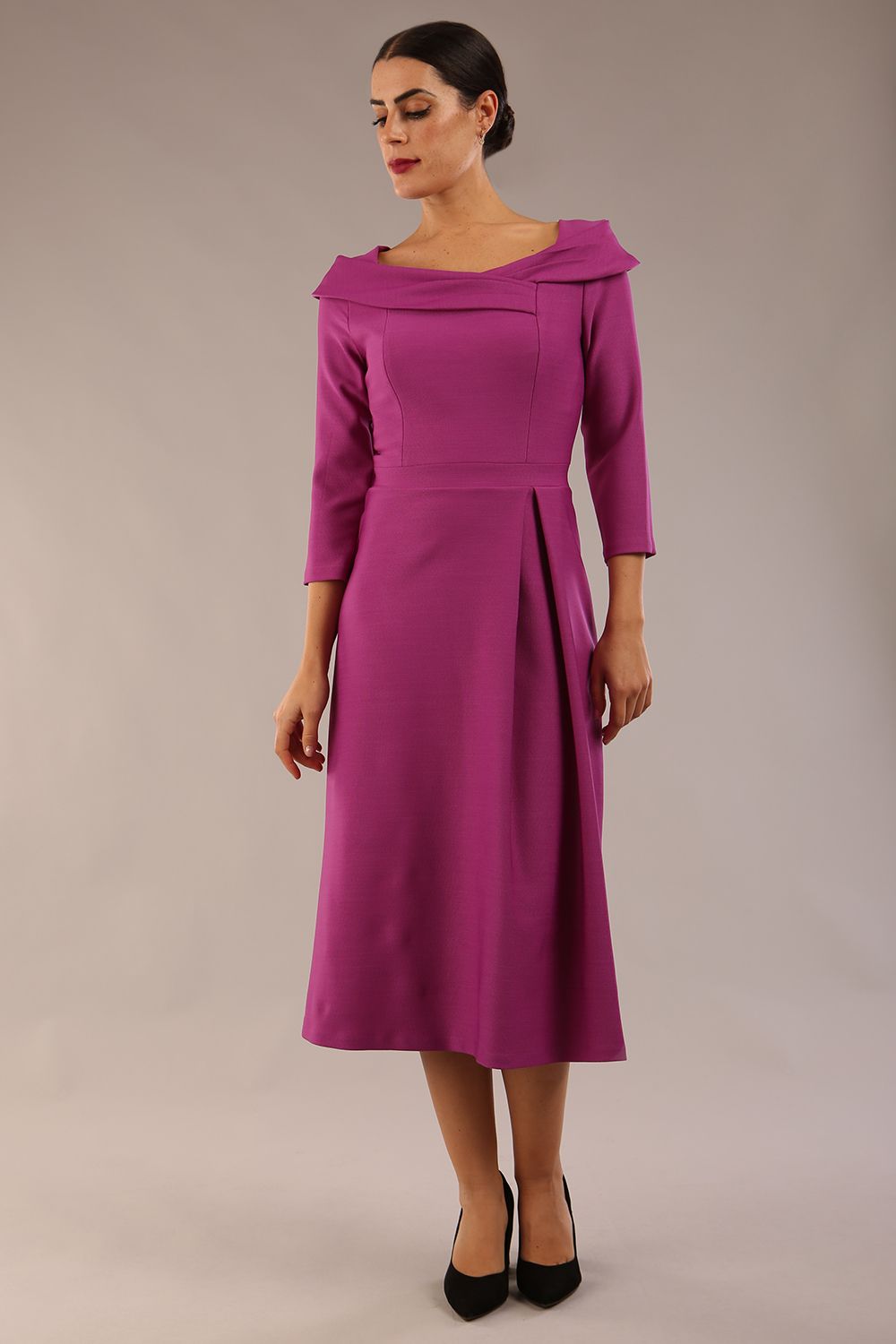 A model wearing a diva catwalk SEED Chrysanta sculptural collar dress 3/4 sleeve A-line dress with a round neckline and concealed zip at the back (Dawn Purple)