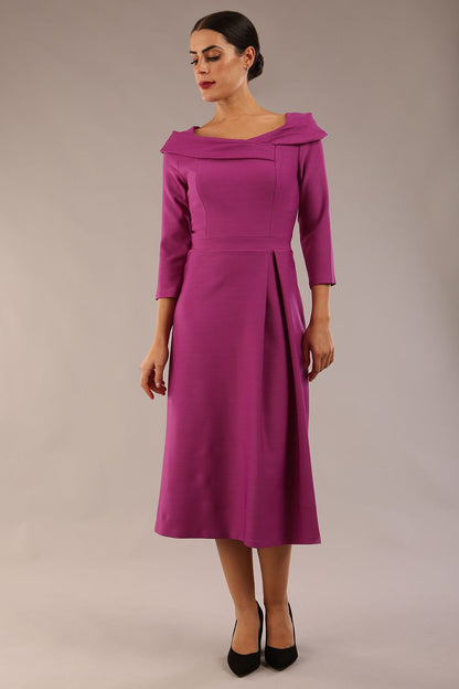 A model wearing a diva catwalk SEED Chrysanta sculptural collar dress 3/4 sleeve A-line dress with a round neckline and concealed zip at the back (Dawn Purple)