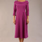 A model wearing a diva catwalk SEED Chrysanta sculptural collar dress 3/4 sleeve A-line dress with a round neckline and concealed zip at the back (Dawn Purple)