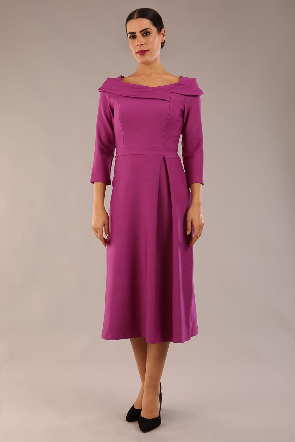 A model wearing a diva catwalk SEED Chrysanta sculptural collar dress 3/4 sleeve A-line dress with a round neckline and concealed zip at the back (Dawn Purple)