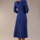 A model wearing a diva catwalk SEED Chrysanta sculptural collar dress 3/4 sleeve A-line dress with a round neckline and concealed zip at the back (Monaco Blue)