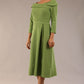 A model wearing a diva catwalk SEED Chrysanta sculptural collar dress 3/4 sleeve A-line dress with a round neckline and concealed zip at the back (Citrus Green)