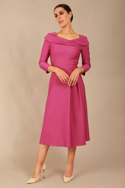 A model wearing a diva catwalk SEED Chrysanta sculptural collar dress in magenta mist 3/4 sleeve A-line dress with a round neckline and concealed zip at the back (Magenta Mist)