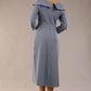 A model wearing a diva catwalk SEED Chrysanta sculptural collar dress 3/4 sleeve A-line dress with a round neckline and concealed zip at the back (Steel Blue)
