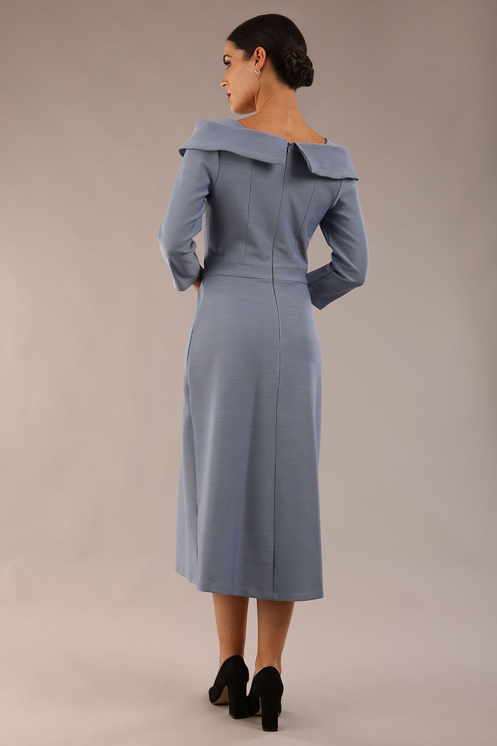 A model wearing a diva catwalk SEED Chrysanta sculptural collar dress 3/4 sleeve A-line dress with a round neckline and concealed zip at the back (Steel Blue)