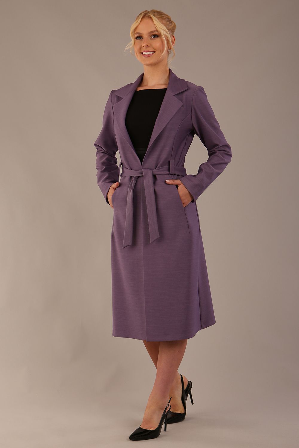 model wearing a diva catwalk Paloma midi coat worn open over a black dress to show its versatility (Dusky Lilac)