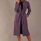 Woman wearing a long purple coat against a plain background (Dusky Lilac)