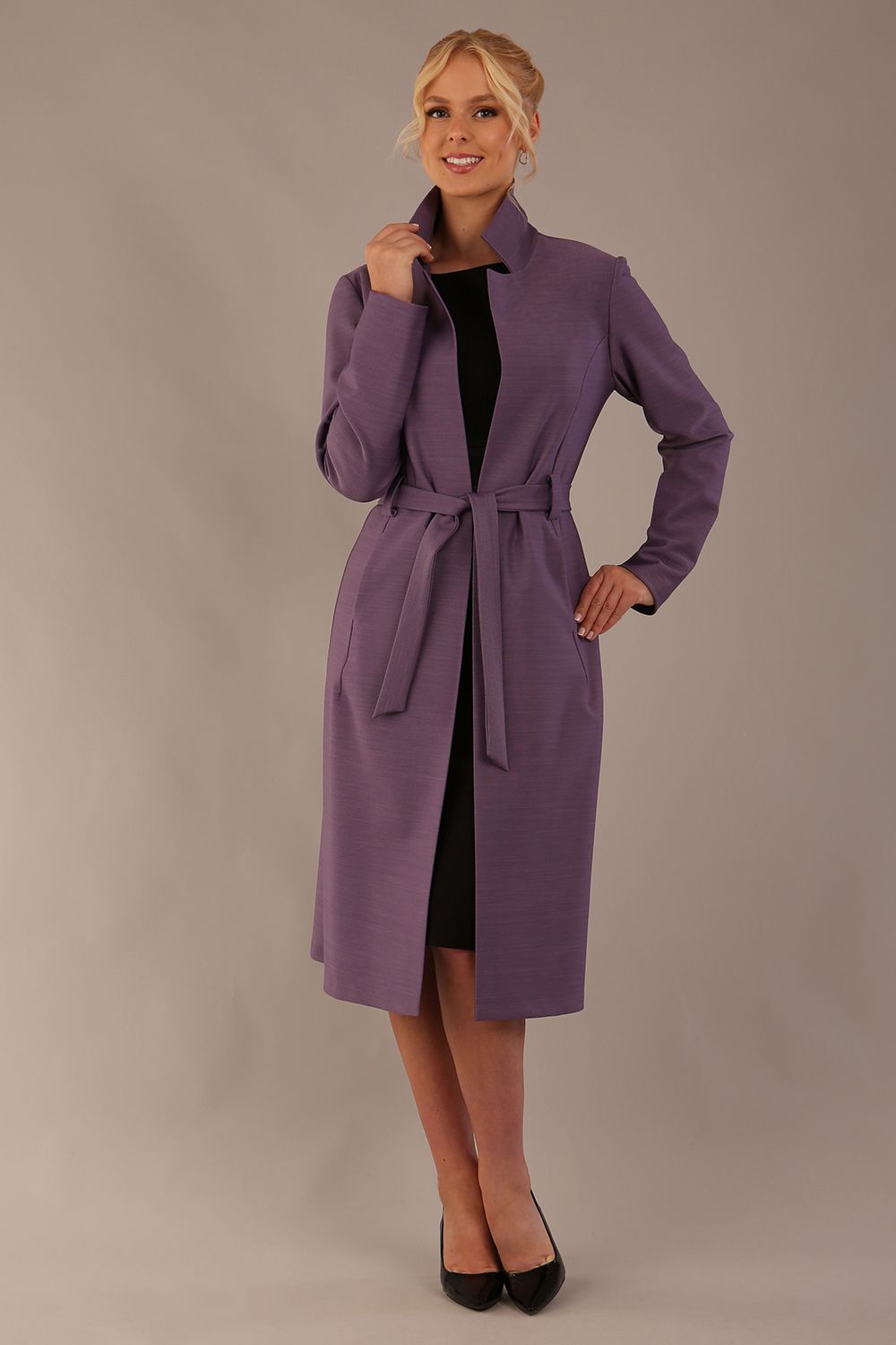 Model wearing the diva catwalk Paloma tie-waist midi coat in dusky lilac, with the belt cinched and collar up (Dusky Lilac)