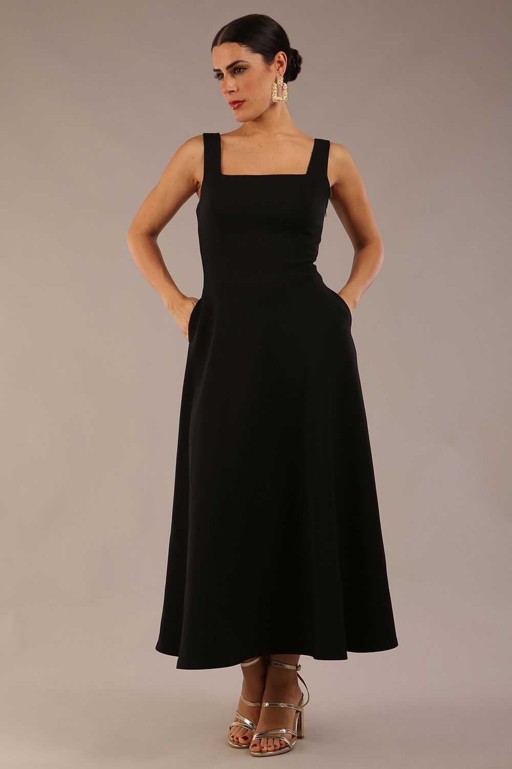 model wearing a diva catwalk Tamsin Square Neckline Swing Dress sleeveless style with a midaxi  length and side pockets in Black colour