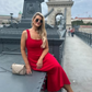 woman wearing a diva catwalk Tamsin Square Neckline Swing Dress sleeveless style with a midaxi  length and side pockets in Scarlet Red colour in Budapest