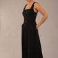 model wearing a diva catwalk Tamsin Square Neckline Swing Dress sleeveless style with a midaxi  length and side pockets in Black colour