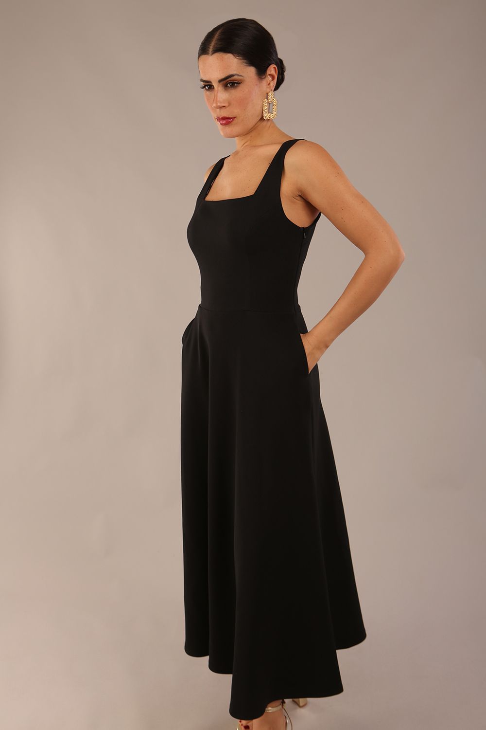 model wearing a diva catwalk Tamsin Square Neckline Swing Dress sleeveless style with a midaxi  length and side pockets in Black colour