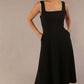model wearing a diva catwalk Tamsin Square Neckline Swing Dress sleeveless style with a midaxi  length and side pockets in Black colour