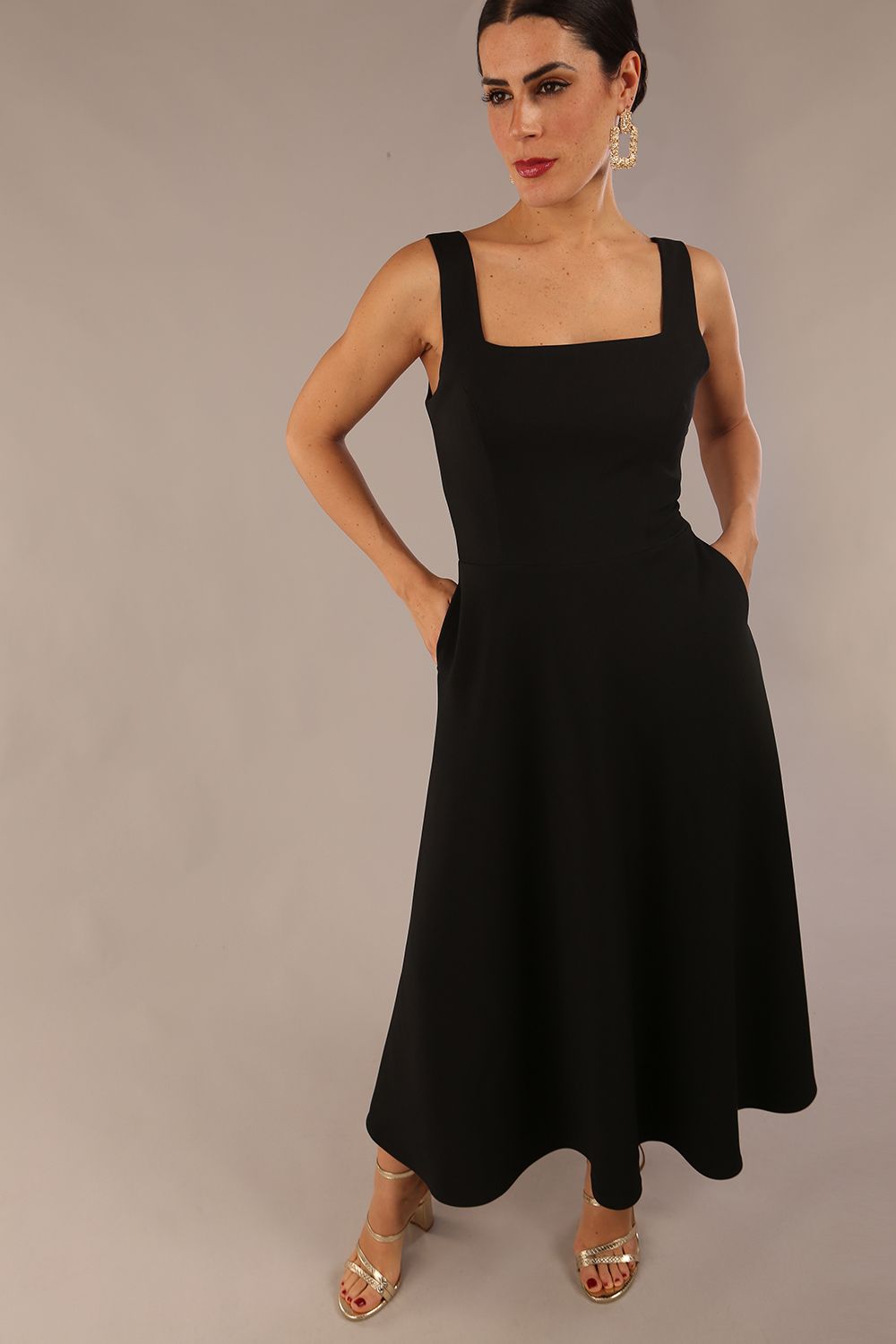 model wearing a diva catwalk Tamsin Square Neckline Swing Dress sleeveless style with a midaxi  length and side pockets in Black colour