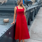 woman wearing a diva catwalk Tamsin Square Neckline Swing Dress sleeveless style with a midaxi  length and side pockets in Scarlet Red colour in Budapest