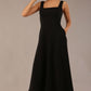 model wearing a diva catwalk Tamsin Square Neckline Swing Dress sleeveless style with a midaxi  length and side pockets in Black colour