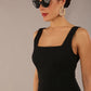 model wearing a diva catwalk Tamsin Square Neckline Swing Dress sleeveless style with a midaxi  length and side pockets in Black colour